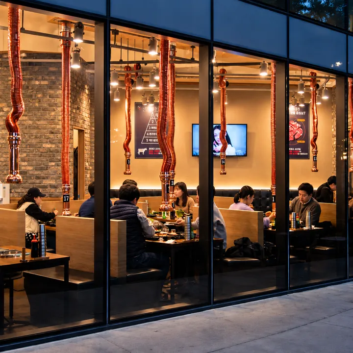 Diners at a Korean barbecue restaurant seen through the front windows